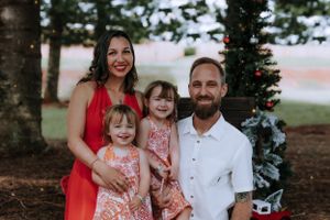 Candid family moments captured during an outdoor Christmas photo session.