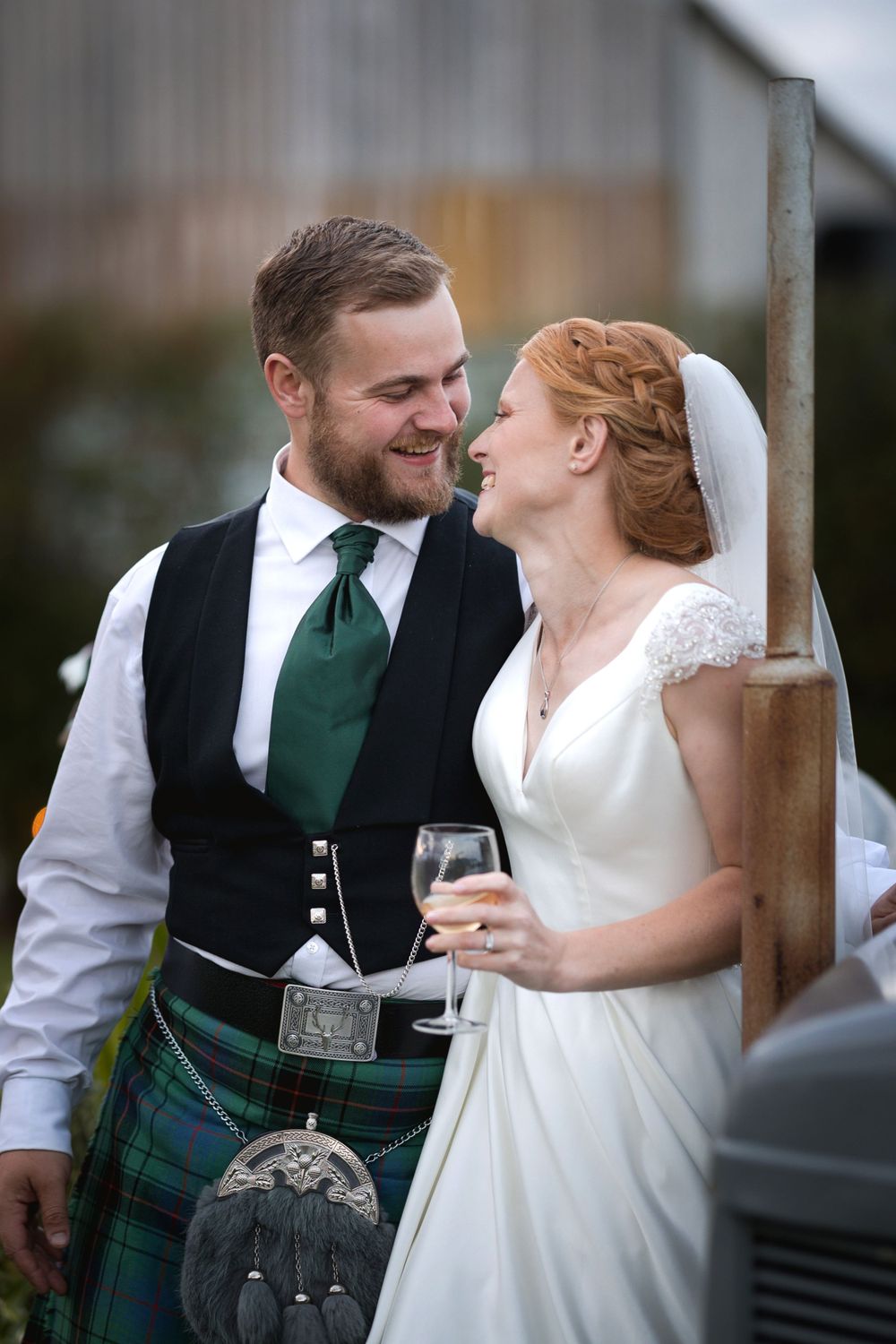 A wedding couple sharing an intimate moment, with the groom wearing traditional Scottish kilt attire.
Preston, Lancashire wedding photograp