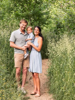 young family of three on beautiful wildflower path