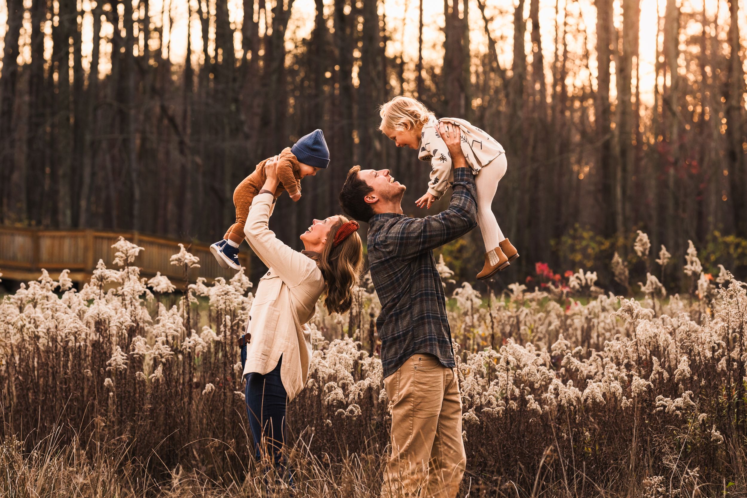 Sunset fall photography of parents lifting children