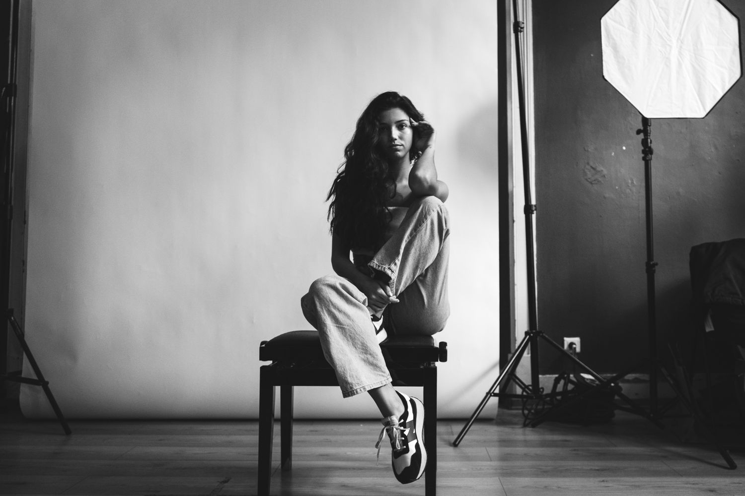 Black and white studio photography setup with lighting equipment and shadows.