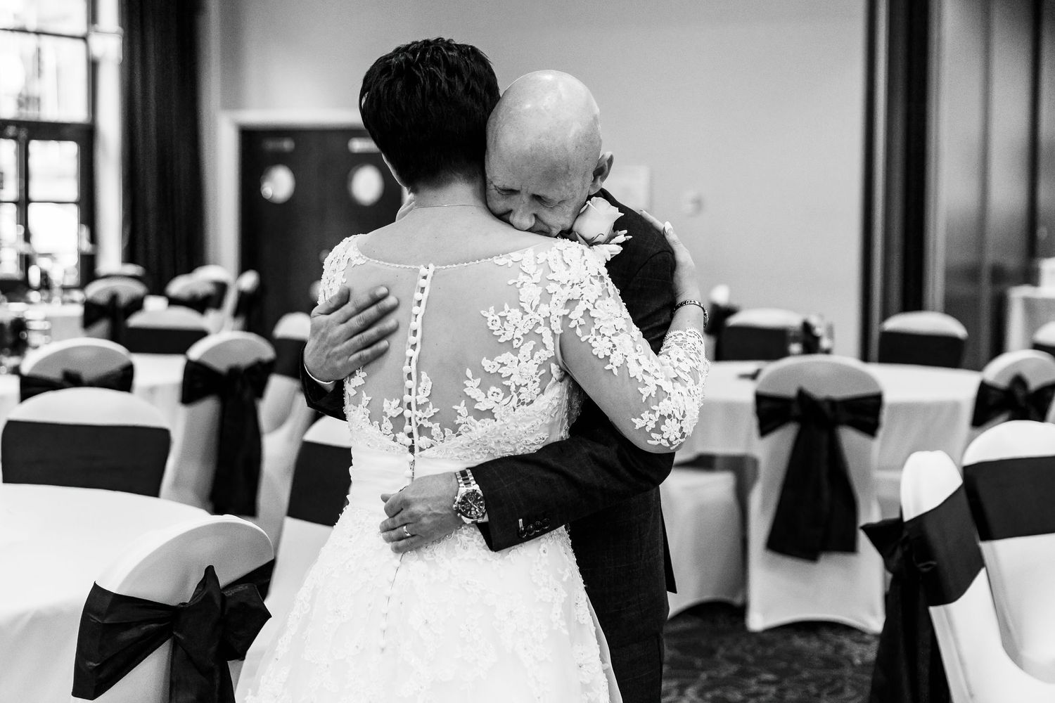 Bride and groom share a  hug before the wedding guests come in for the reception. Liverpool wedding photography.