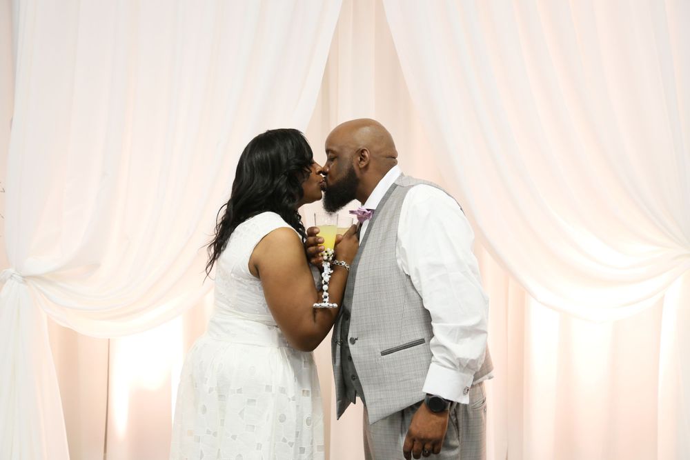 Eternal bond sealed with a tender kiss, as the bride and groom share a heartfelt moment of love and unity on their speci