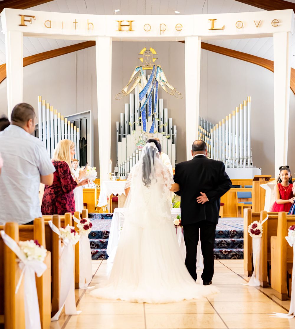 Tender moment captured as the radiant bride stands at the altar, accompanied by her loving father.