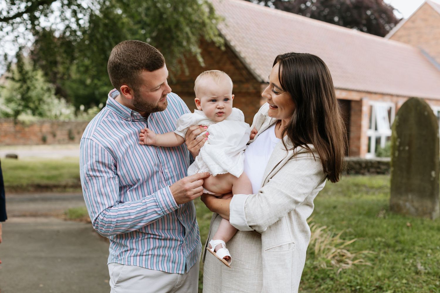 Family sharing a tender moment together outside their home.