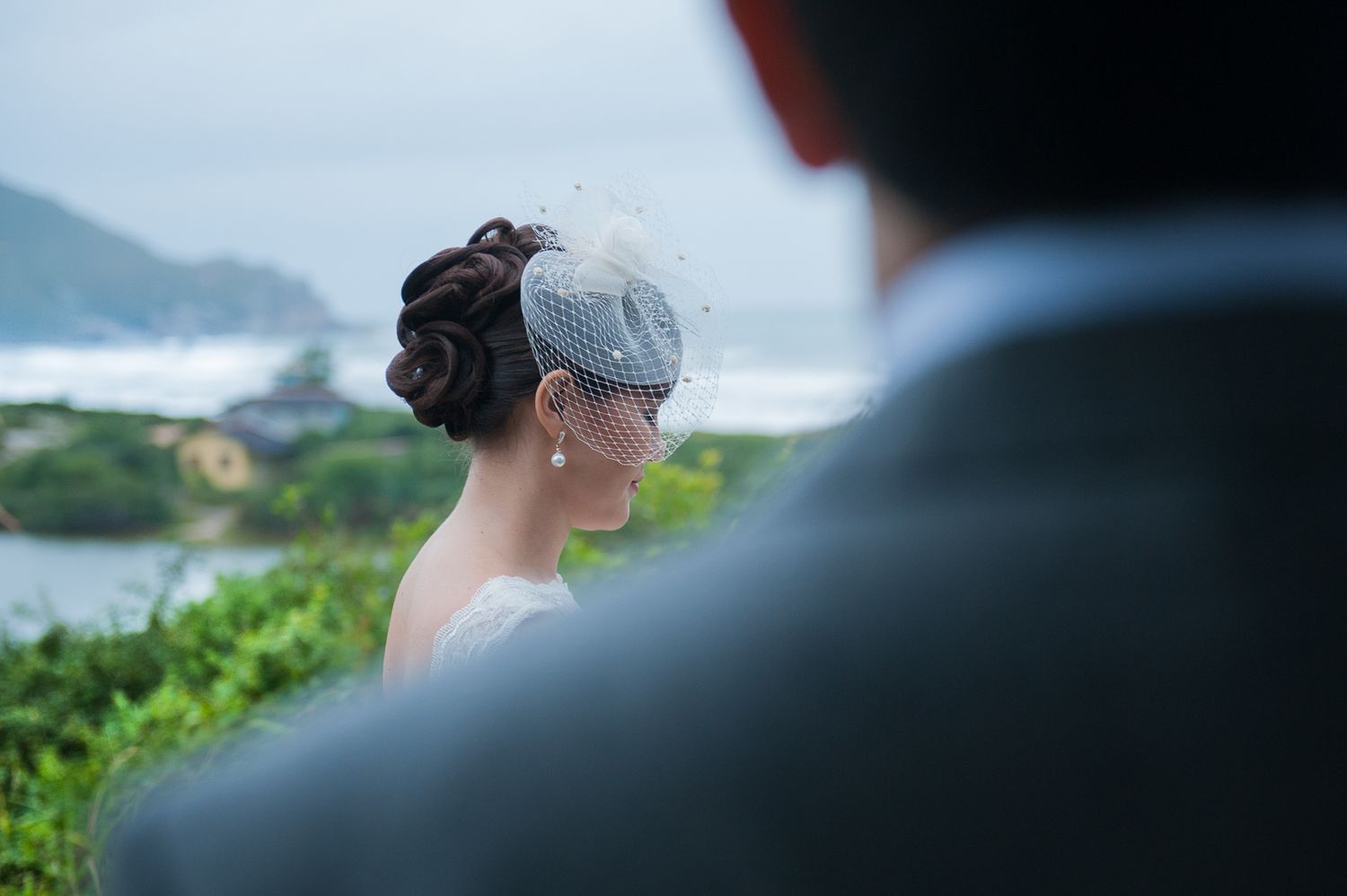 A scenic coastal view with soft focus on wedding attire details.