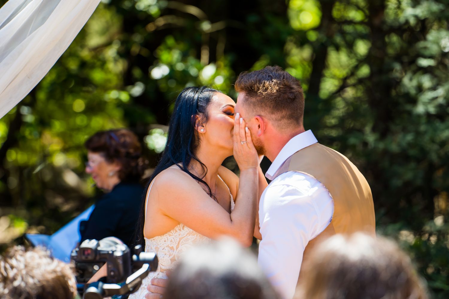 Wedding couple sharing intimate moment during outdoor ceremony.