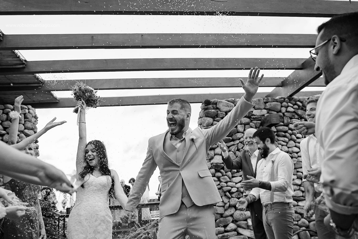 A celebratory moment captured in black and white during a wedding reception.