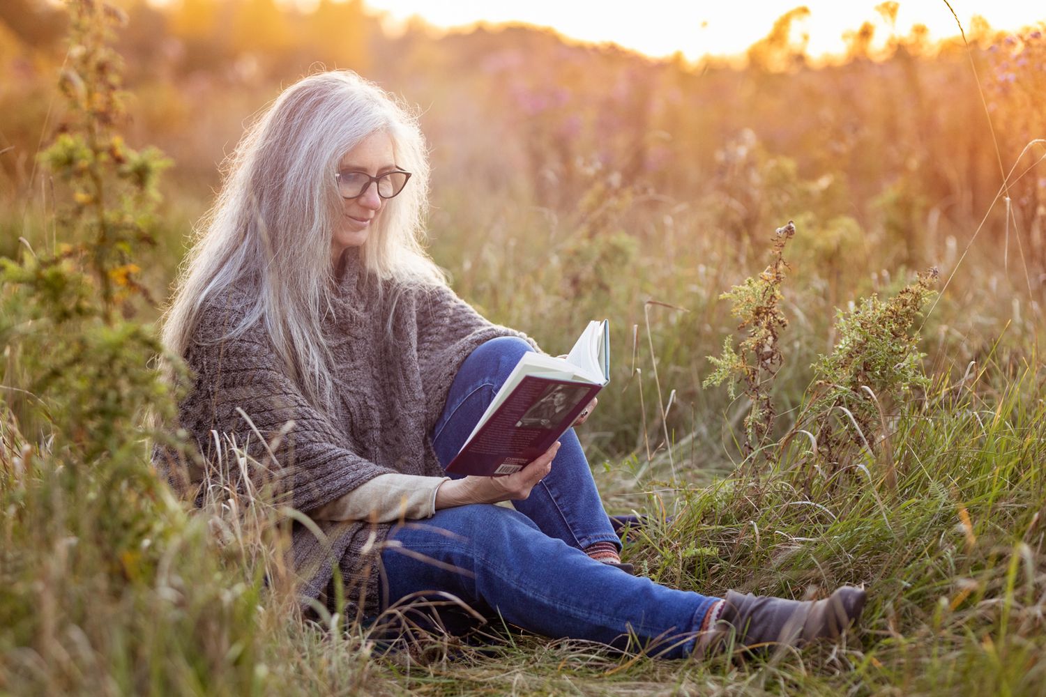 Branding photography of a woman reading in a field