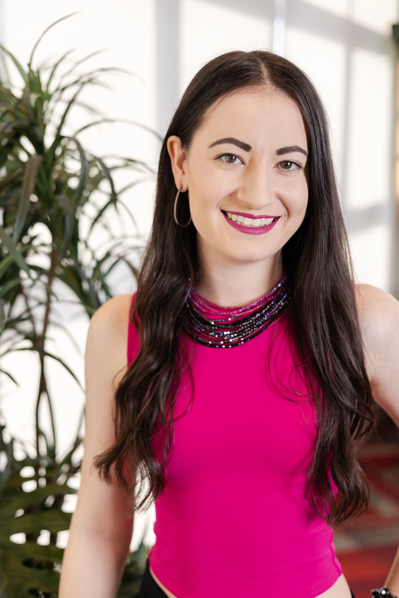 Carley's Acupuncture woman business owner smiling for headshot wearing pink in Issaquah, WA