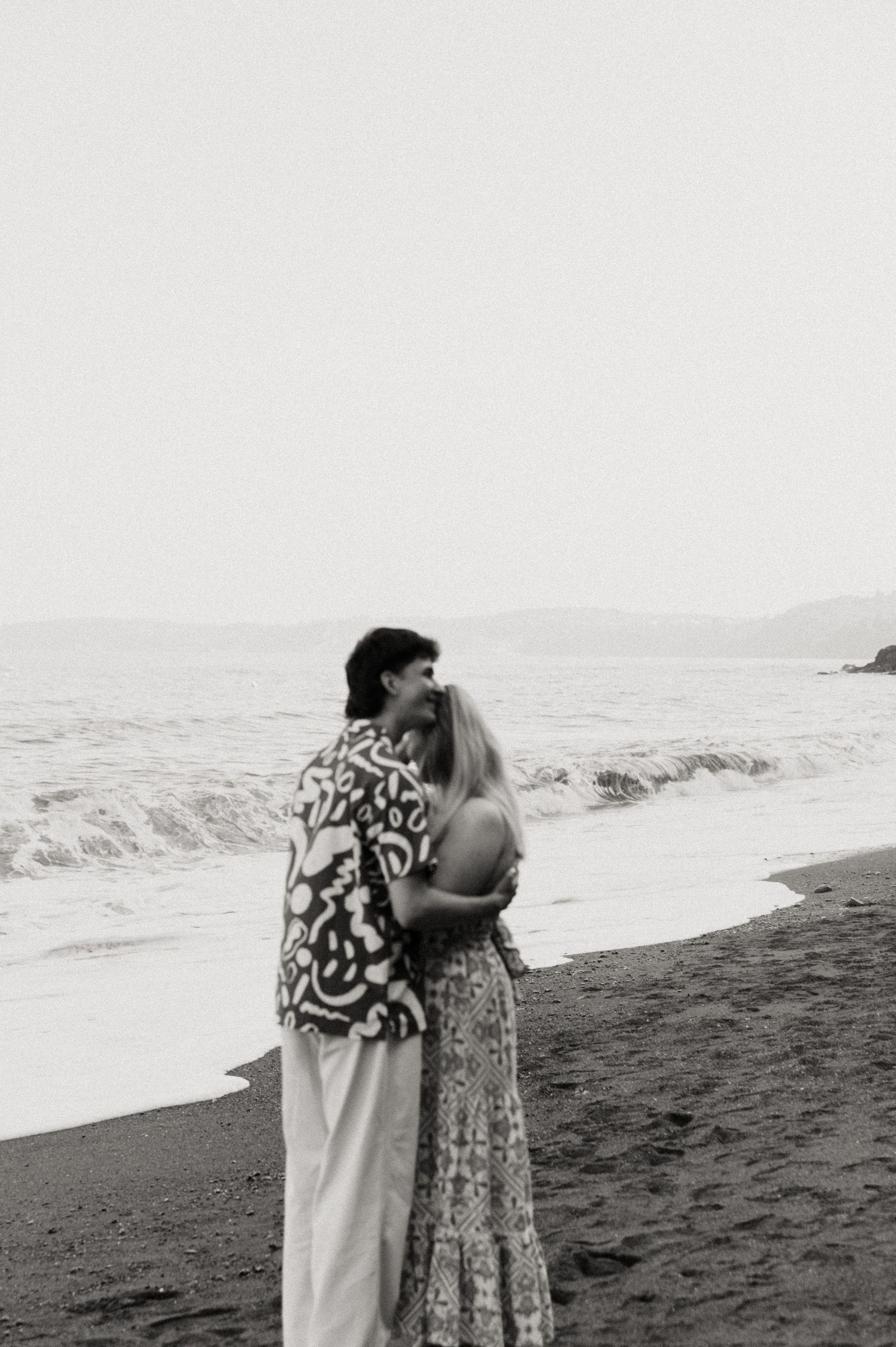 Newly engaged couple cuddling after proposing at Shaldon Beach