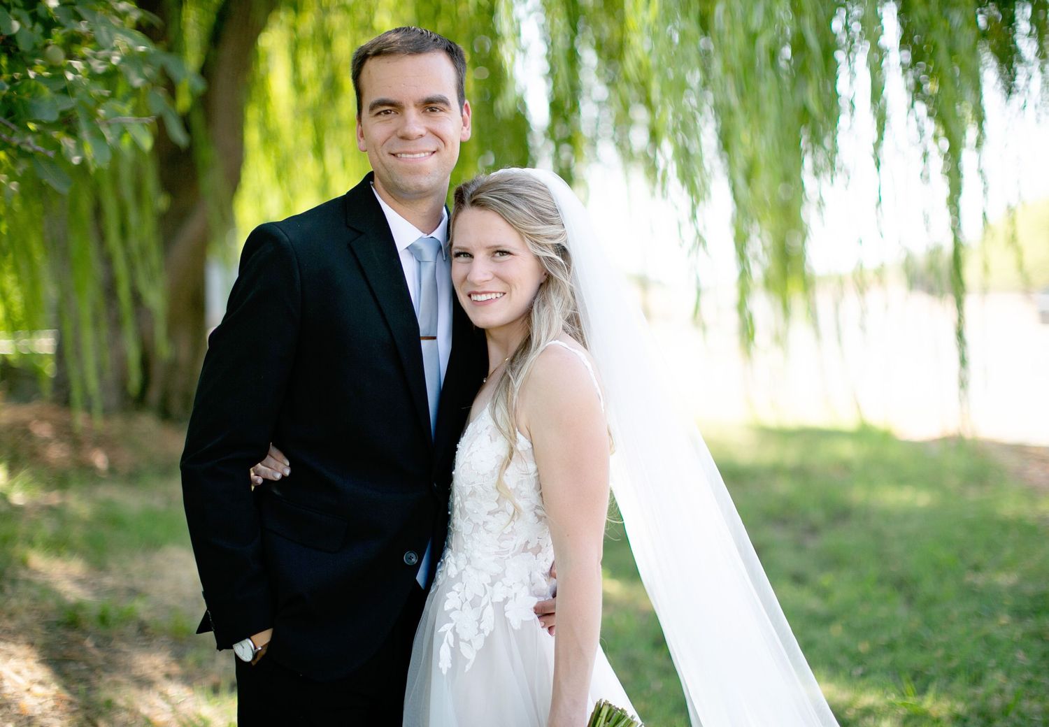 Bride and Groom in Orland, California Wedding with willow tree behind them and green grass