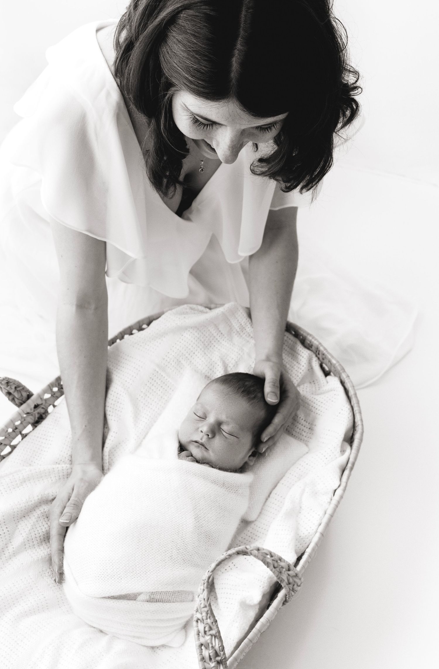 Mother showing love to her new baby at photography studio in Victoria BC
