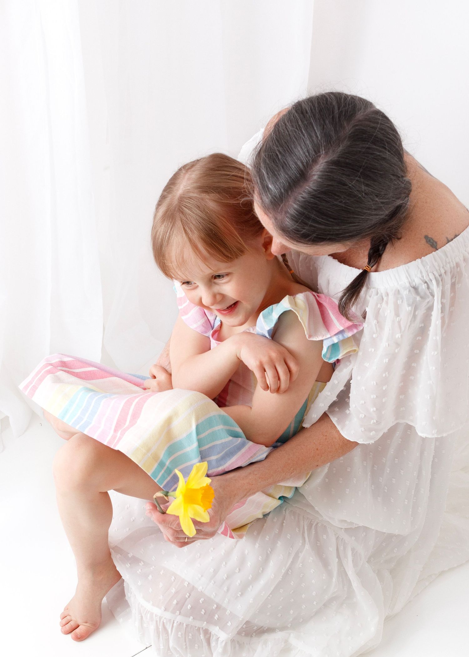 Mama hugging her daughter during mothers day photography mini shoot