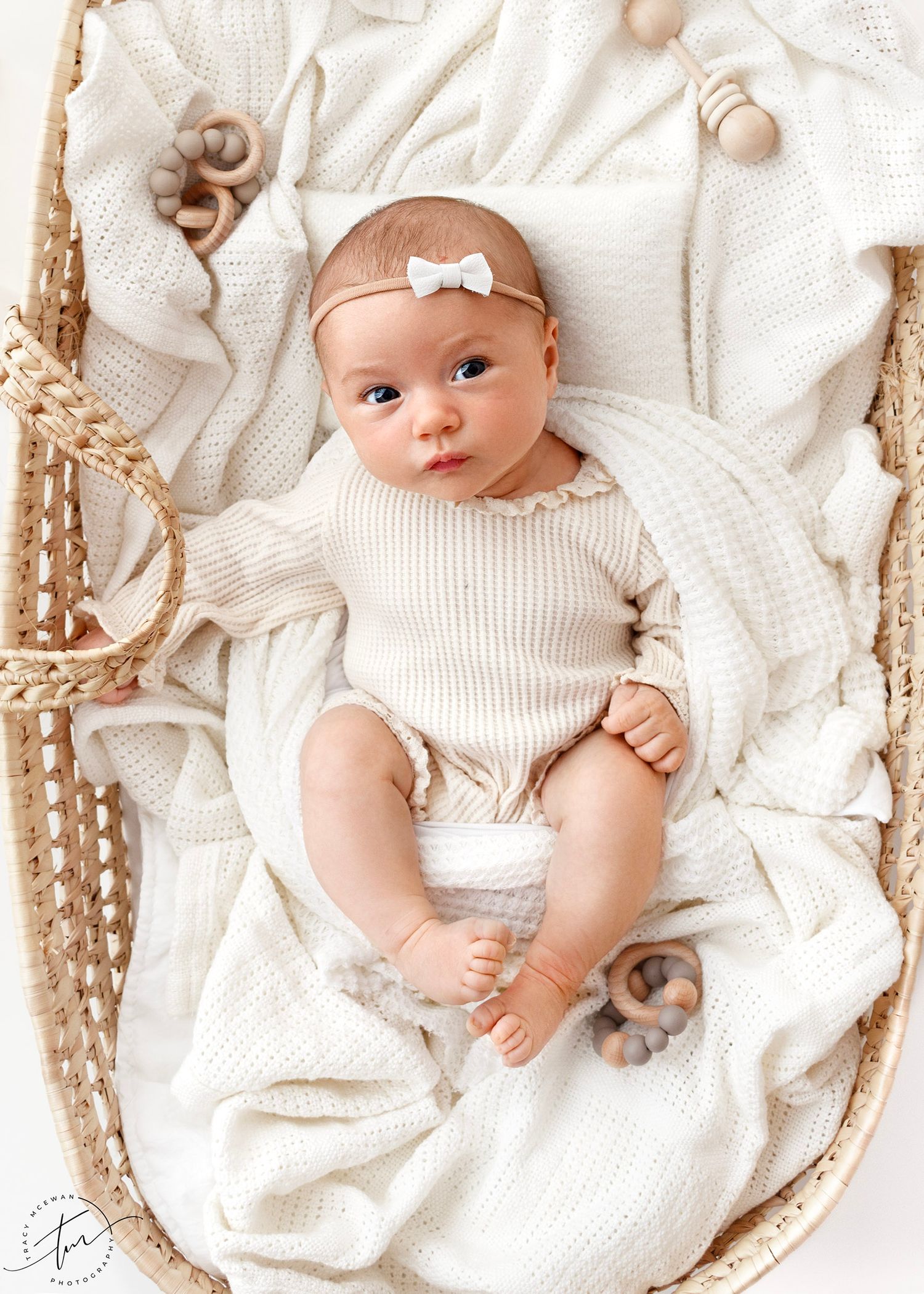 Older baby in a bassinet during newborn photography photoshoot
