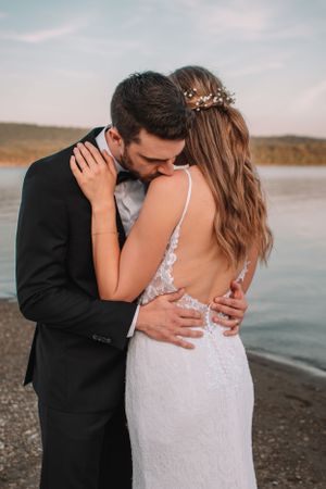 Romantic wedding portrait captured on a beach at dusk.