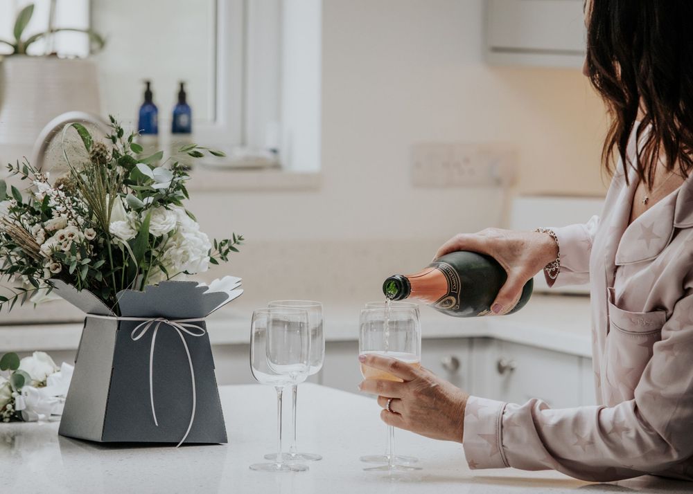 pouring champagne on the morning of the wedding