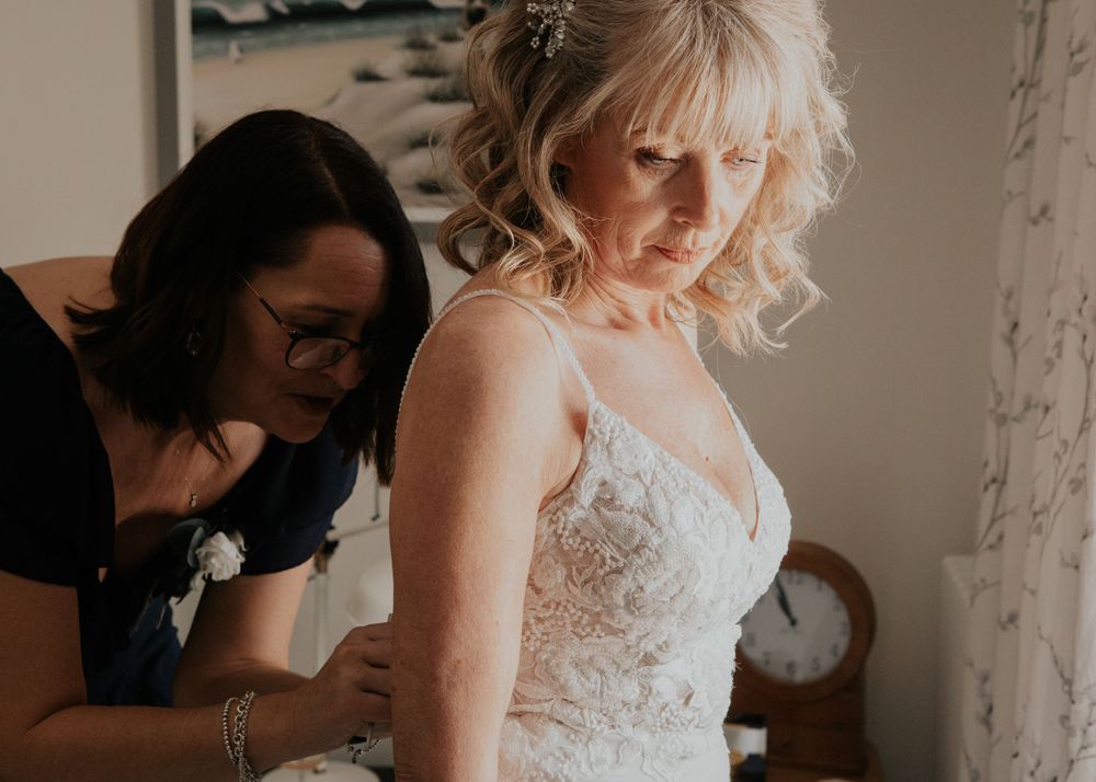 bride getting into her wedding dress photography