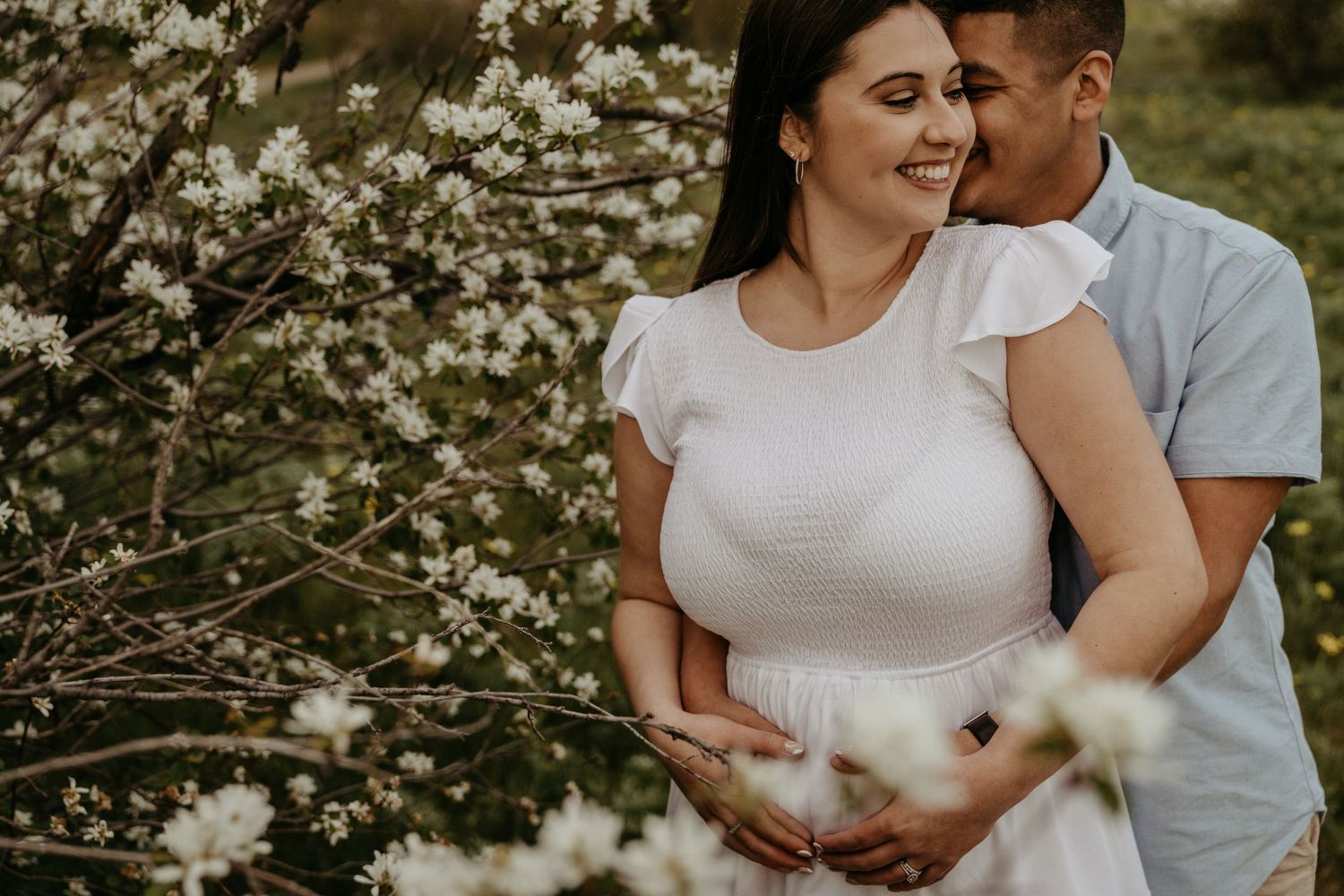 A romantic springtime portrait with blooming cherry blossoms in the background.