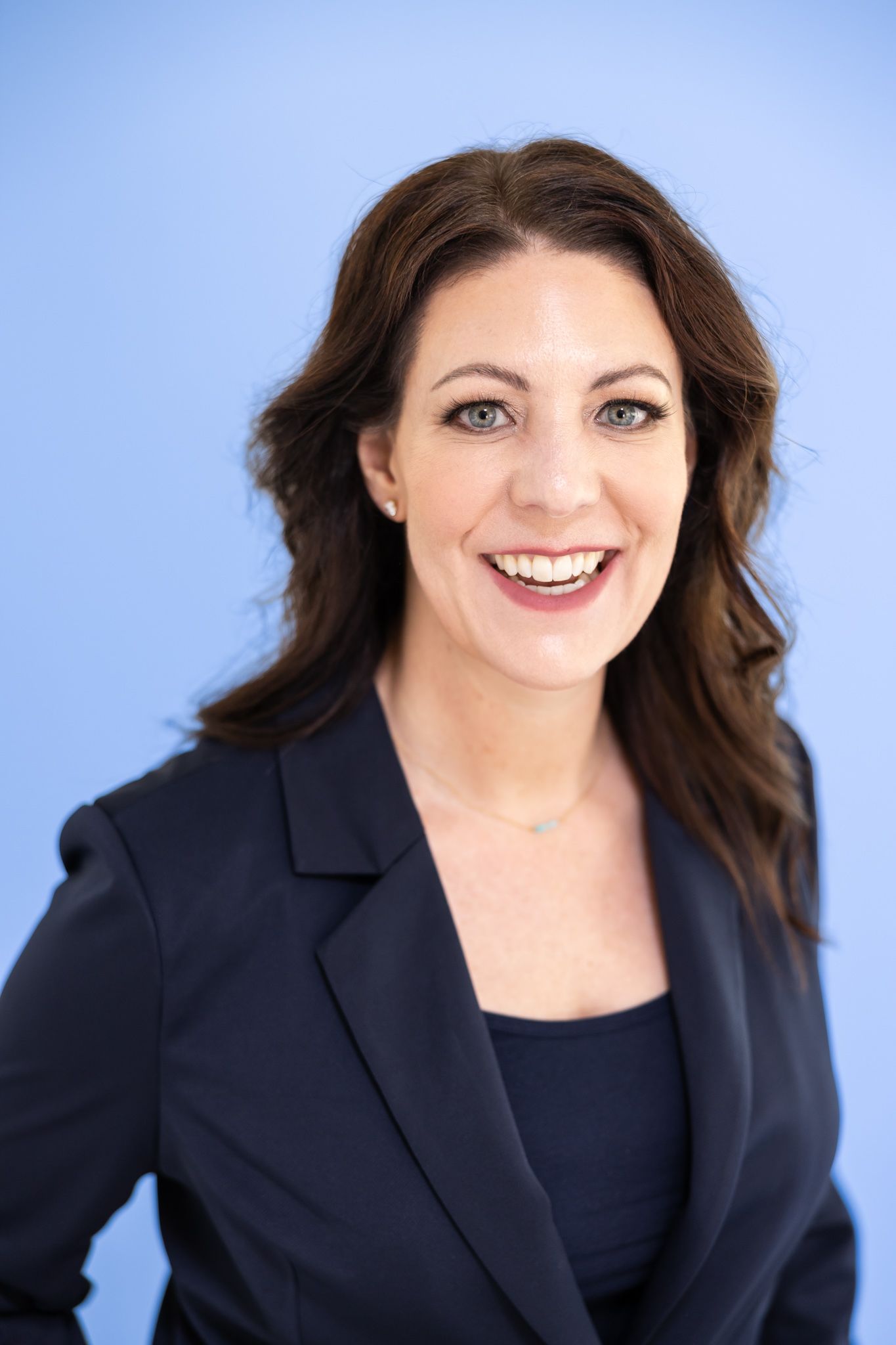 woman headshots against blue background interior commercial designer Woodinville, WA
