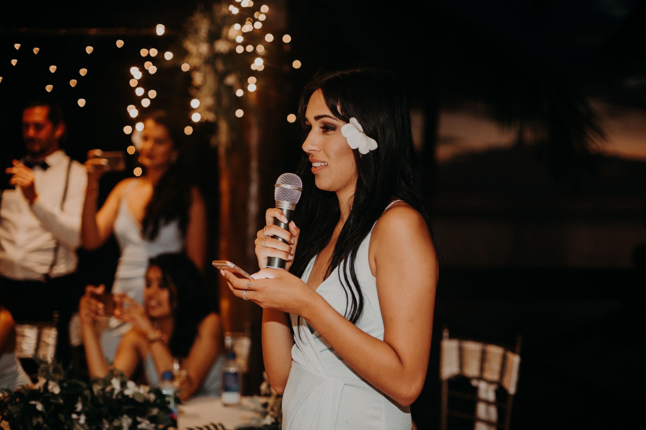 Wedding guest delivering an emotional toast during evening reception.