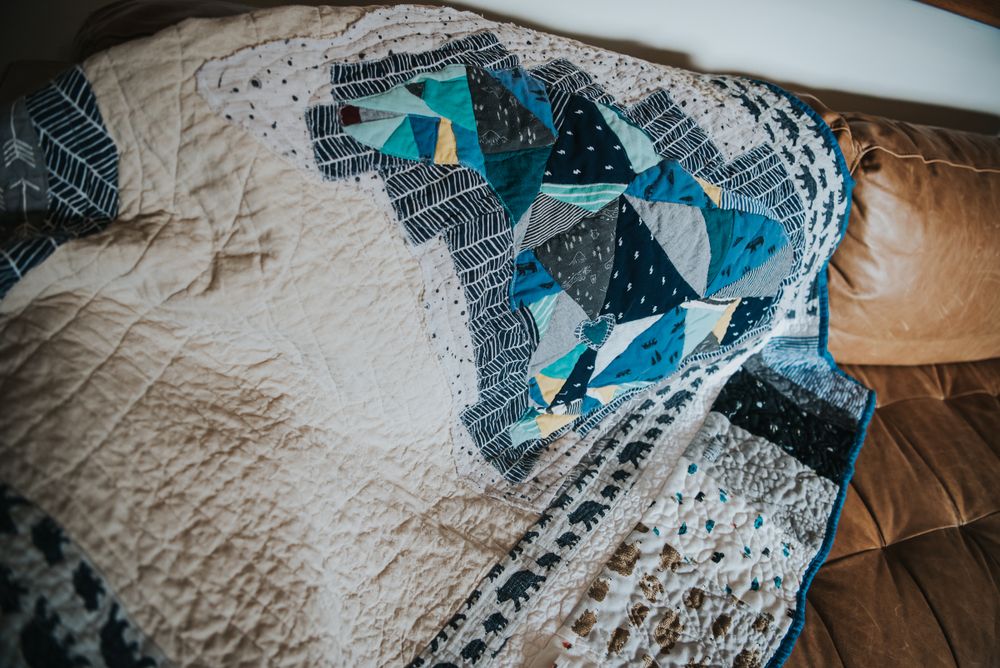 Pieced bear quilt made with baby clothes.