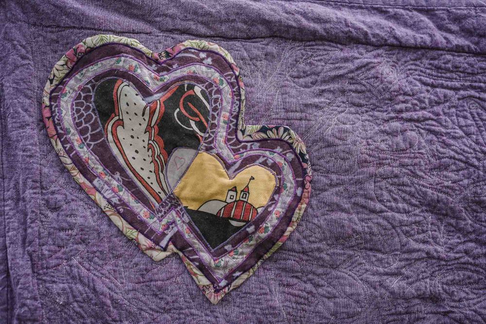 Two hearts intertwined made from clothing in a memorial quilt.