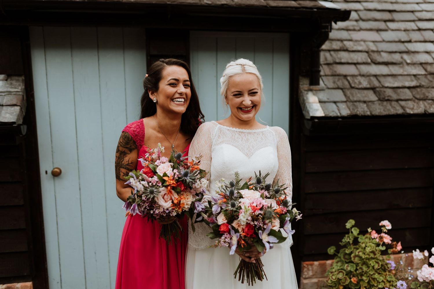 Stunning bride and bridesmaid photographed in garden at family home in Garthmyl before heading to the church