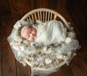 Newborn girl wrapped in floral wrap on a chair. Greenville, SC newborn photographer, Easley, SC Newborn photographer