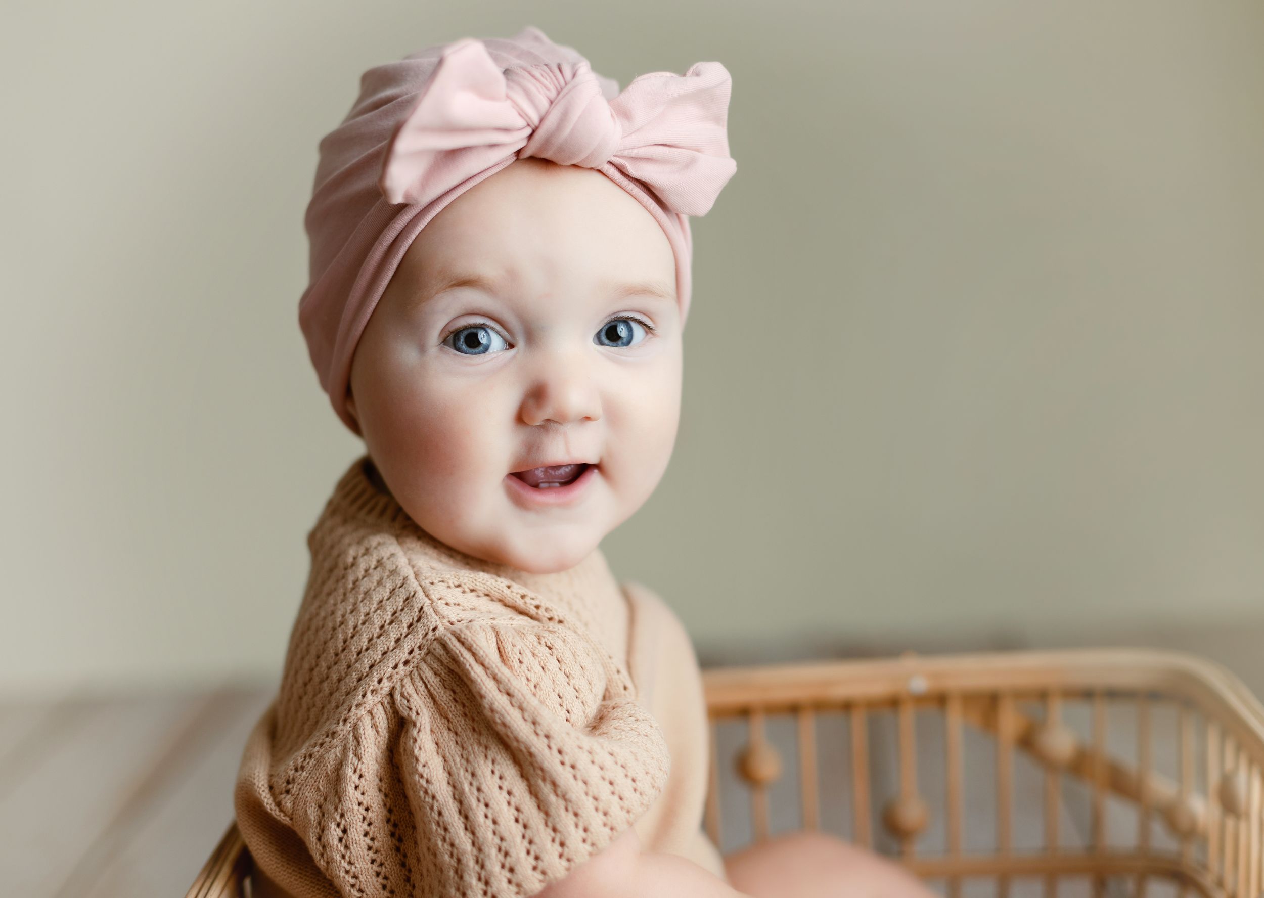 A 9-month-old in a basket with a big bow. Greenville, SC newborn photographer, Easley, SC Newborn photographer