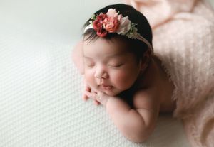 Profile shot of a newborn girl with the chin-on-hands pose. Greenville, SC newborn photographer, Easley, SC Newborn photographer