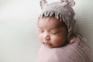 A newborn baby girl with a purple bear hat. Greenville, SC newborn photographer, Easley, SC Newborn photographer