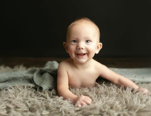 A 6-month-old boy laughing at the camera. Greenville, SC newborn photographer, Easley, SC Newborn photographer