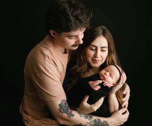 Mom and Dad embracing holding their newborn baby. Greenville, SC newborn photographer, Easley, SC Newborn photographer