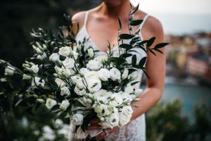 Bride holding bridal florals in Cinque Terre, Italy.