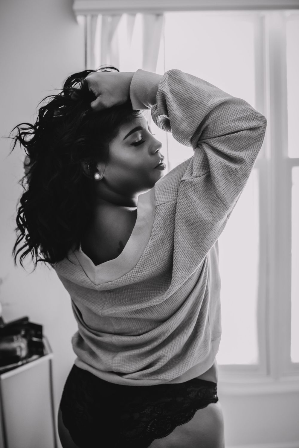 African American woman in sweater for boudoir