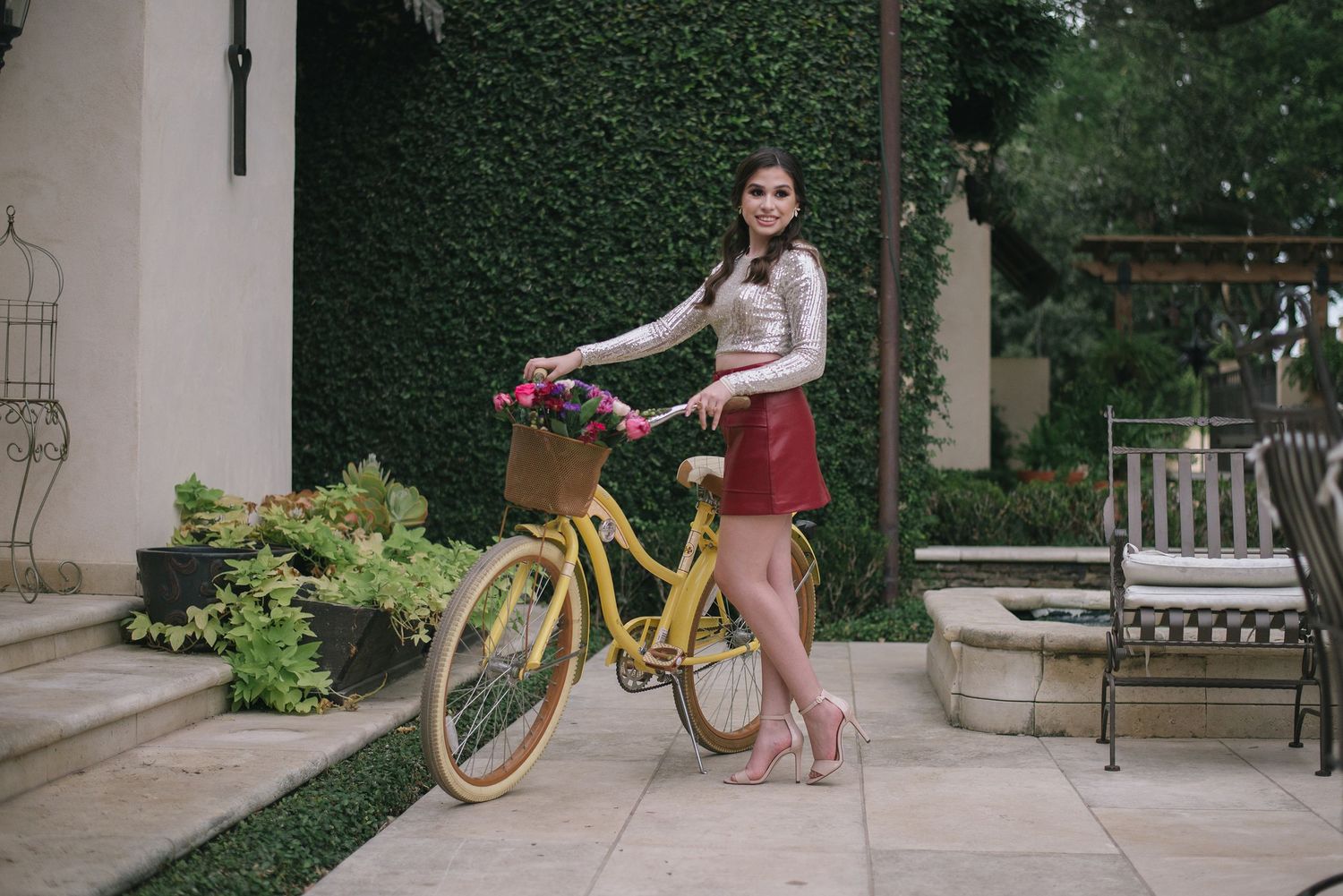 Vintage yellow bicycle adds charm to garden portrait against ivy wall.