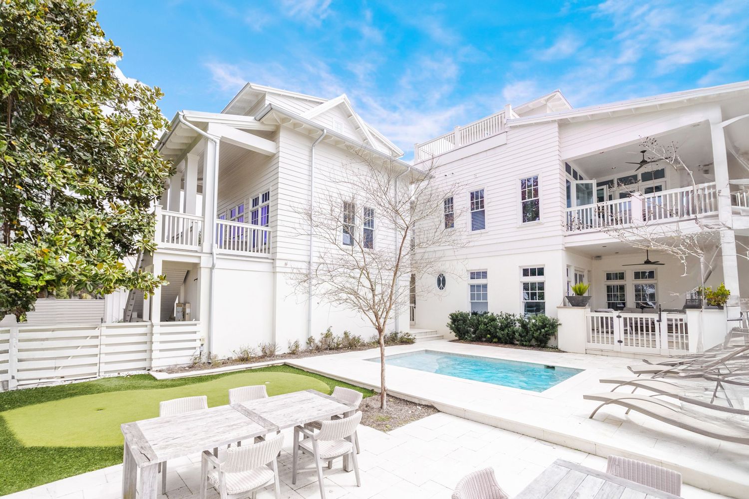 Dive into luxury with this stunning poolside view of a beach home in Rosemary Beach FL
