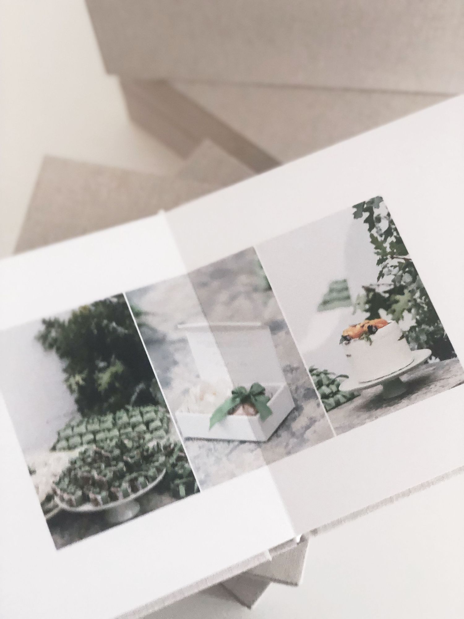 Wedding photo album displaying landscape photographs in minimalist gray binding.