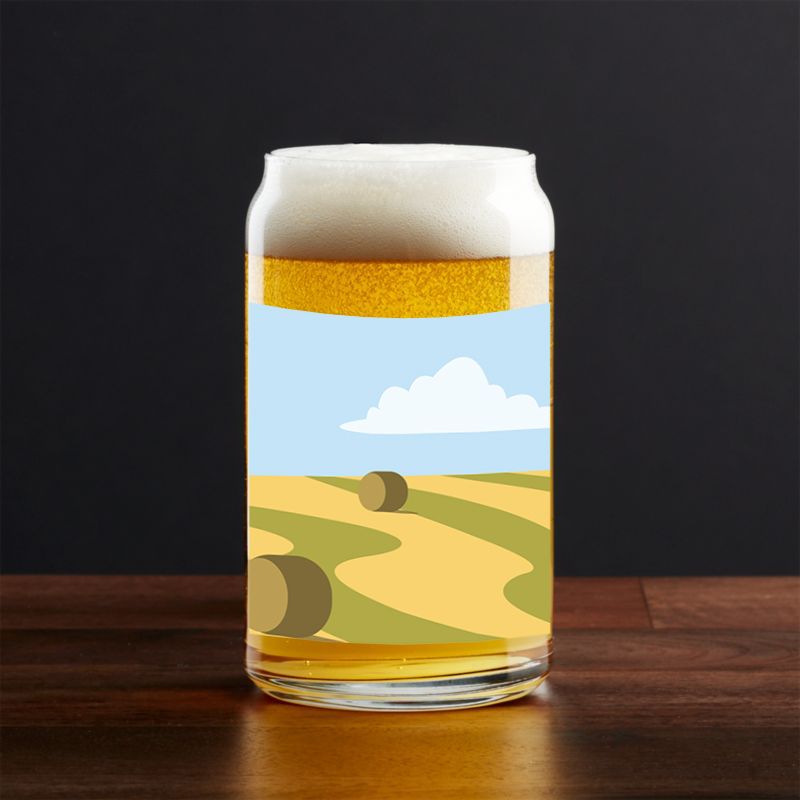 Craft beer glasses with rolling hills and hay bale artwork against black backdrop.