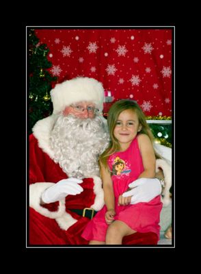 Holiday portrait with decorated Christmas tree and snowflake backdrop.