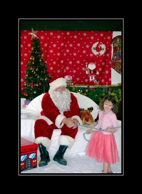 Festive Christmas scene with decorated tree and small dog on white chair.