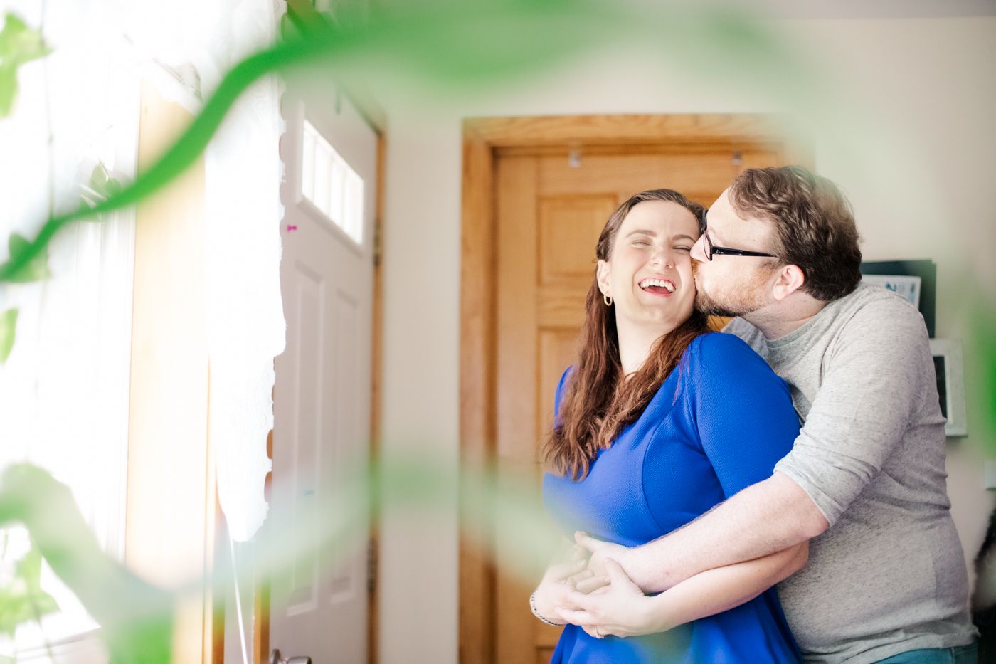 Man kisses woman's cheek smiling during an anniversary session in Gardiner, NY with Danielle Lauren Photography