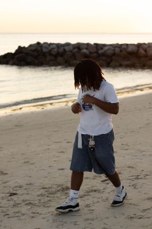Brother walking on the beach during sunset