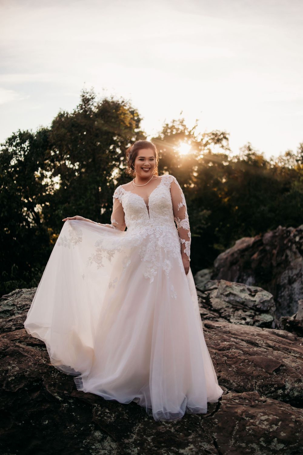 bride holding wedding dress