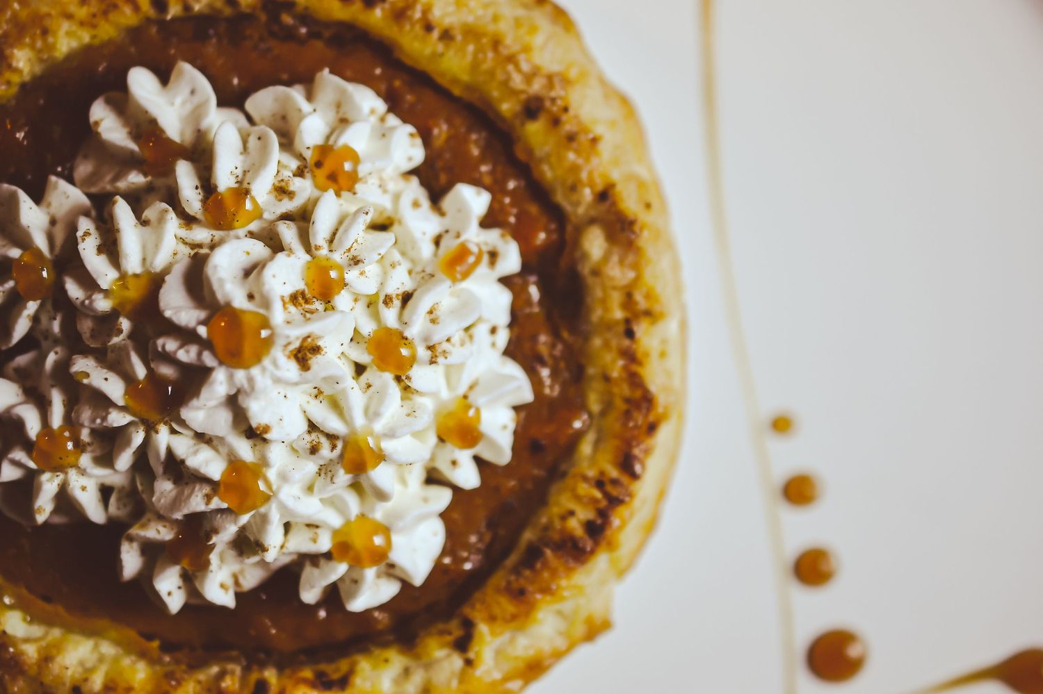 Close up of chocolate dessert topped with whipped cream and caramel drizzle.