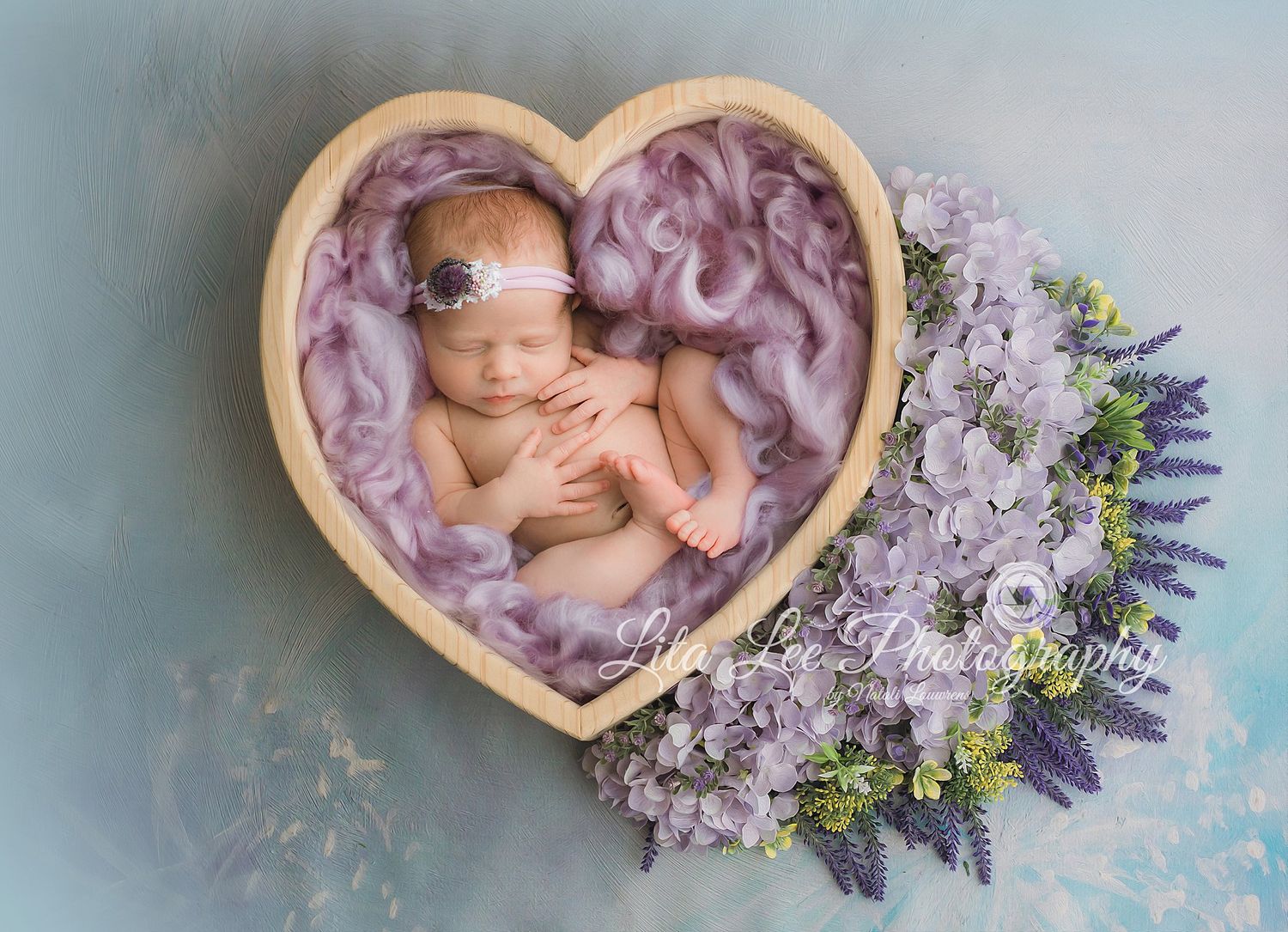 Baby in heart and lavender flowers