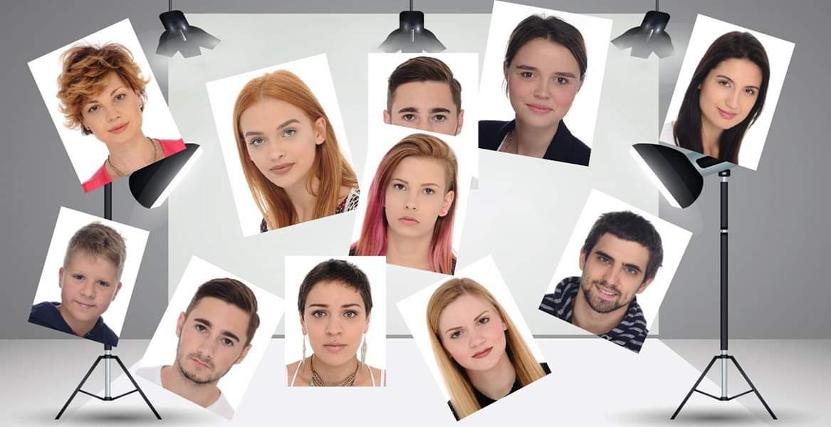 Array of professional headshot photographs displayed with studio lighting equipment.