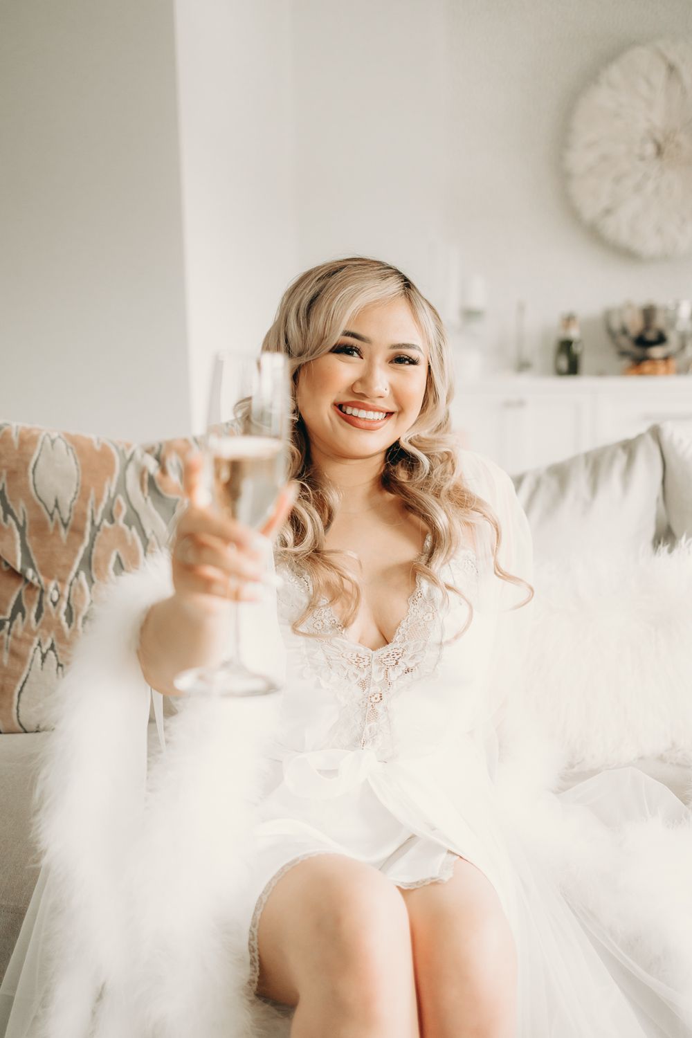 bride in bridal suite holding champagne glass