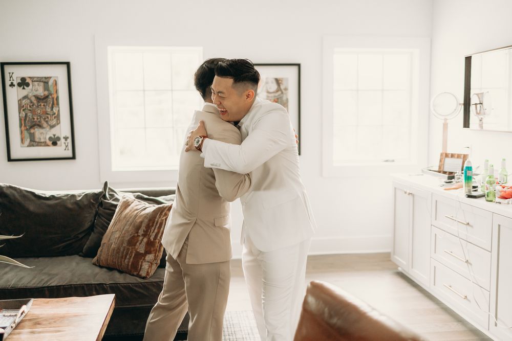 groom hugging friend